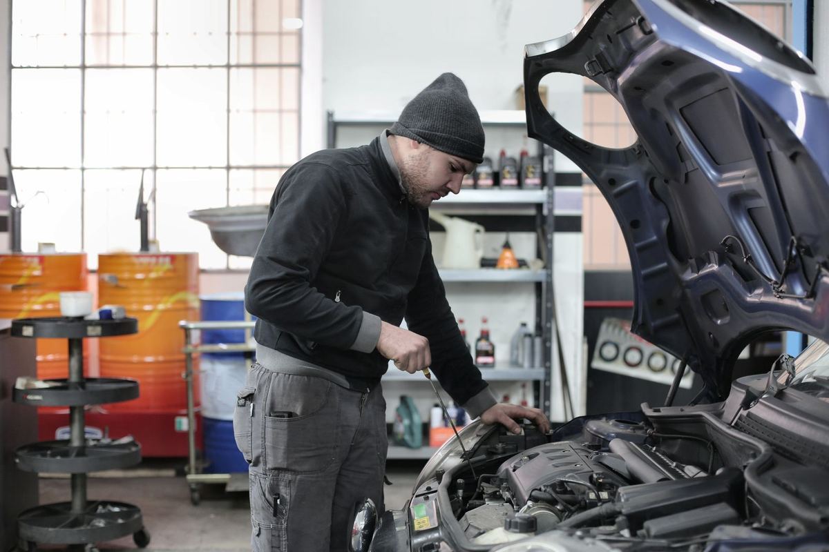 An ARS technician inspecting an engine bay